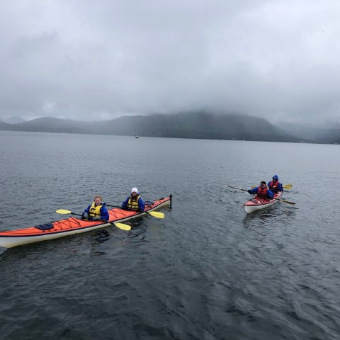 a group of people in a boat on a body of water