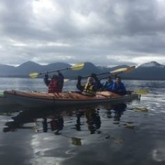 a group of people in a boat on a body of water