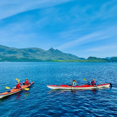 a group of people in a small boat in a body of water